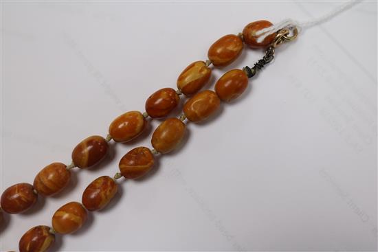 A single strand graduated oval amber bead necklace, with loose beads, gross weight 38 grams, 48cm.